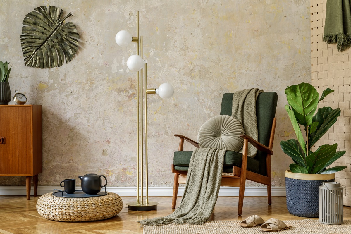 TAUPE/KHAKI color psychology: Modern retro composition of living room interior with design armchair, pouf, tea pot on the tray, plant, plaid, carpet, decoration and elegant personal accessories in wabi sabi concept