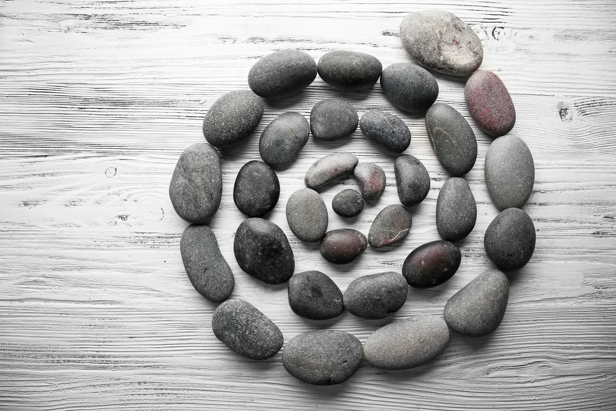 GRAY color psychology: Spa stones on wooden background